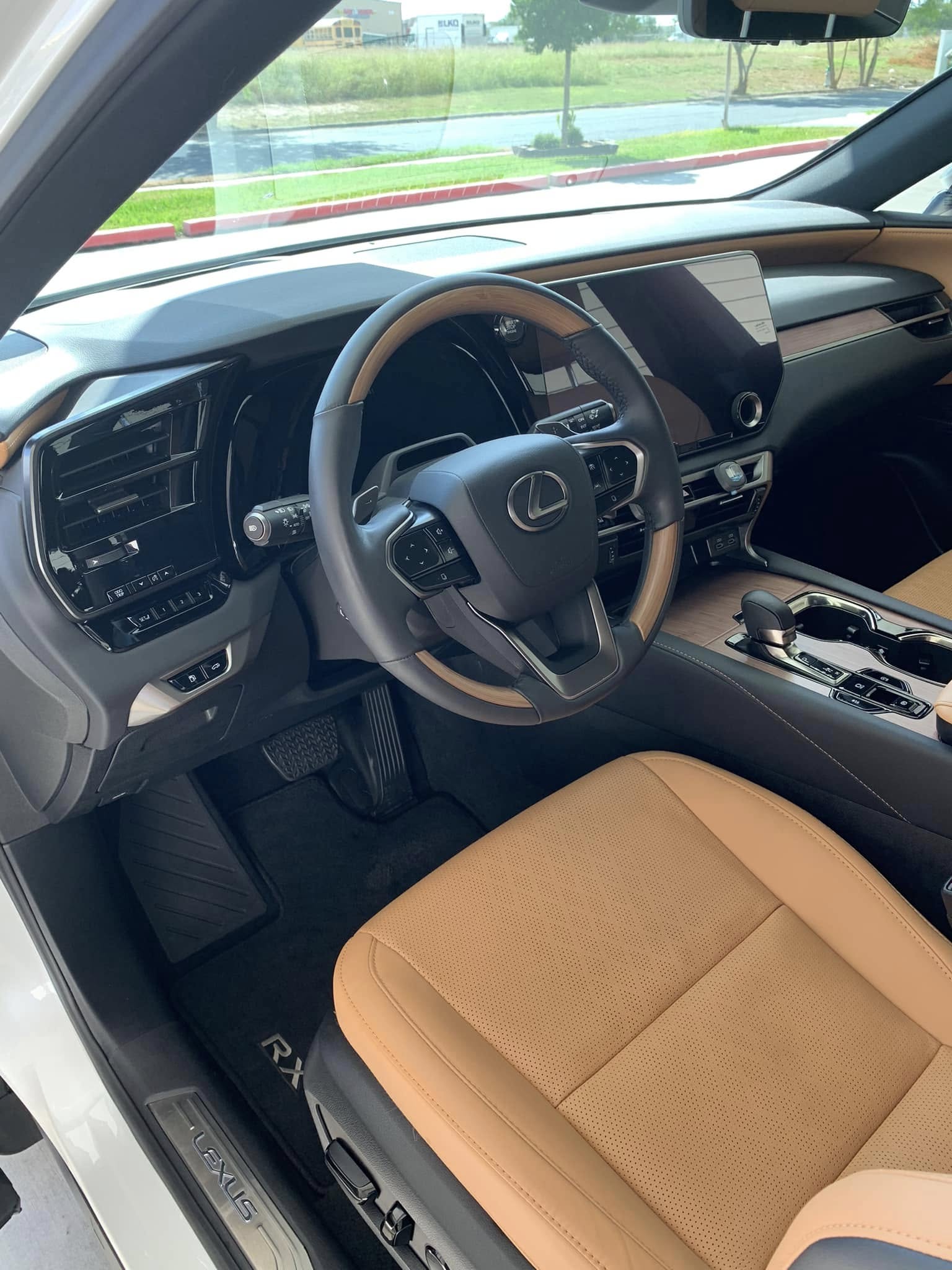 Deep-cleaned tan leather seats, dashboard and wood-trim steering wheel after an interior detail by I Auto Detailing in McAllen, TX