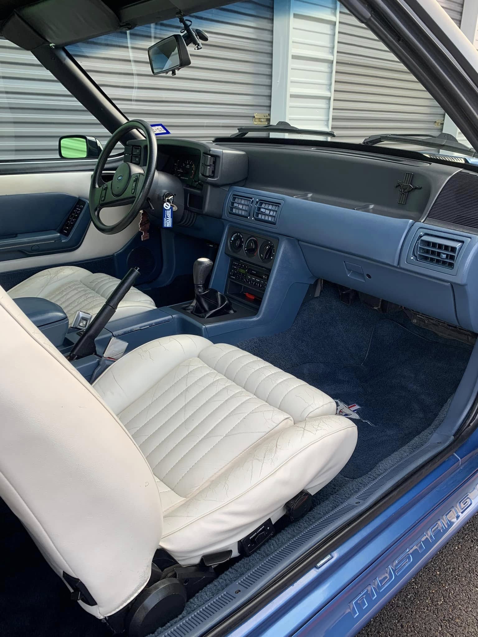 Two-tone blue-and-white interior of a classic Ford Mustang convertible after a detail by I Auto Detailing in Mission, TX