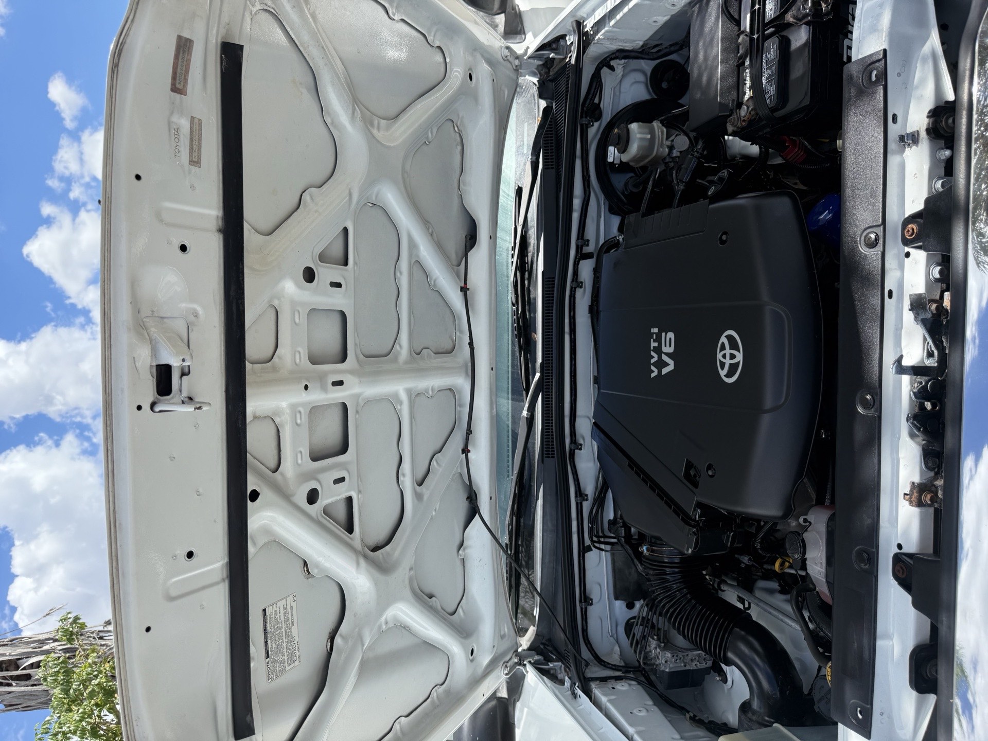 Clean engine bay of a Toyota V6 with the hood raised after an engine-bay detail by I Auto Detailing in the Rio Grande Valley