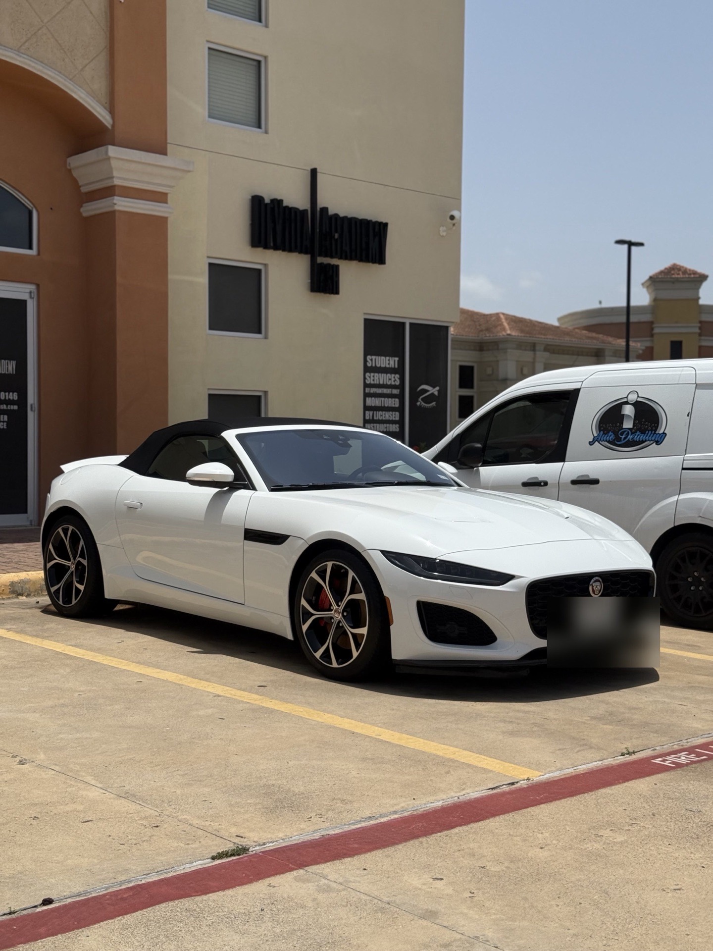 Freshly detailed white Jaguar F-Type convertible parked beside the I Auto Detailing mobile van, showing come-to-you service by I Auto Detailing in McAllen, TX