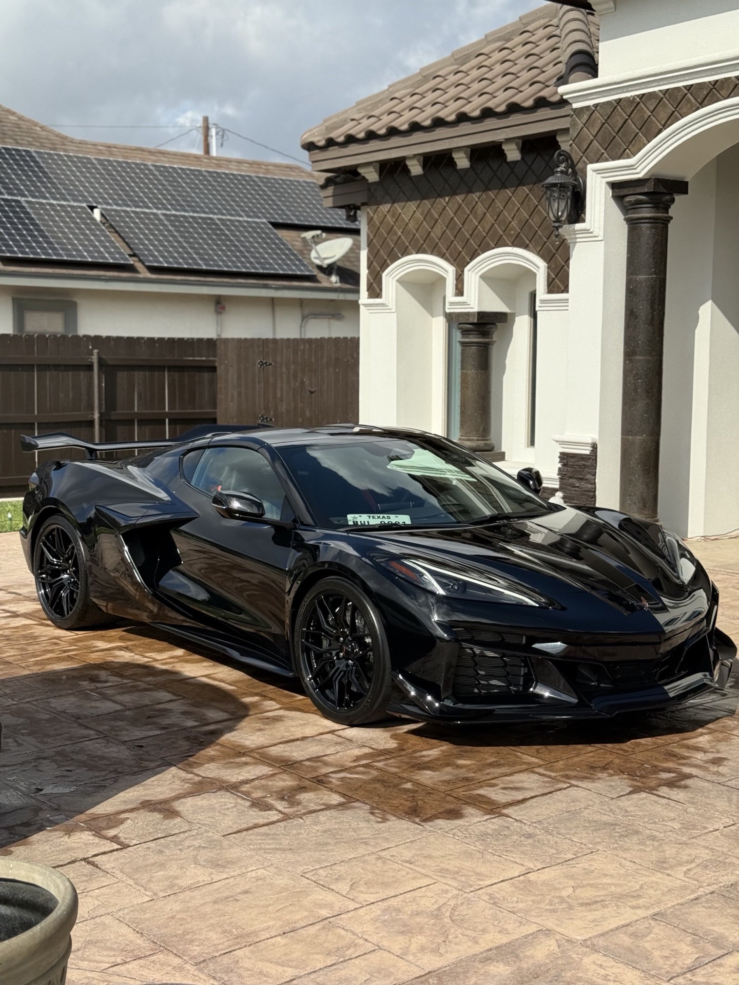 Glossy black sports car with a freshly detailed, protected finish at a McAllen home by I Auto Detailing