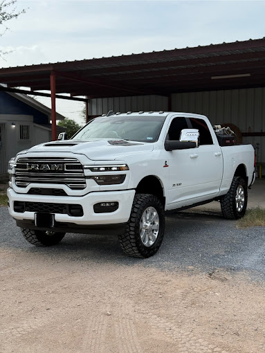 Lifted white Ram 2500 Laramie truck detailed to a glossy finish under a carport by I Auto Detailing in Peñitas, TX