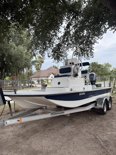 Blue-and-white bay boat on its trailer after a mobile gel-coat cleaning and polish by I Auto Detailing in the Rio Grande Valley
