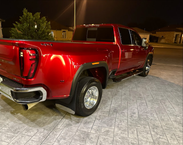 Candy-red GMC dually truck detailed to a deep, glossy shine, photographed at night, by I Auto Detailing in San Juan, TX
